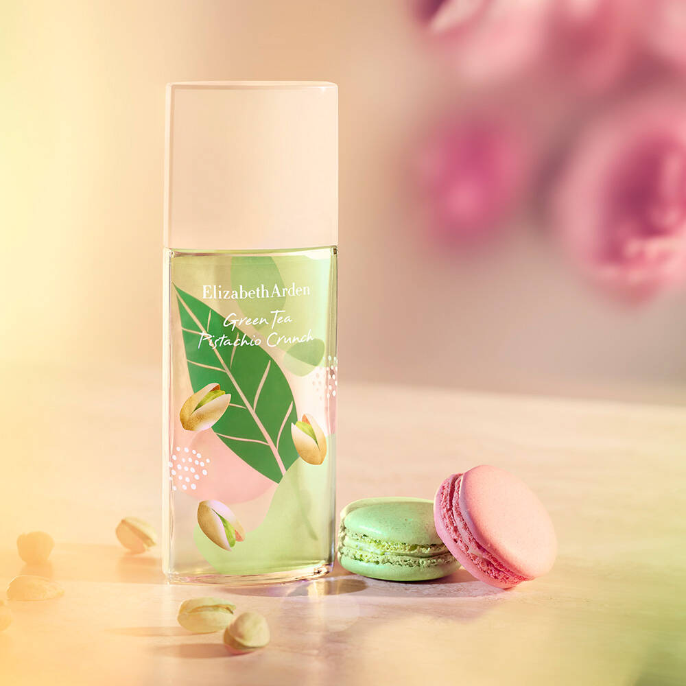 Elizabeth Arden Green Tea Pistachio Creme bottle with a pink macaron on a soft focus background