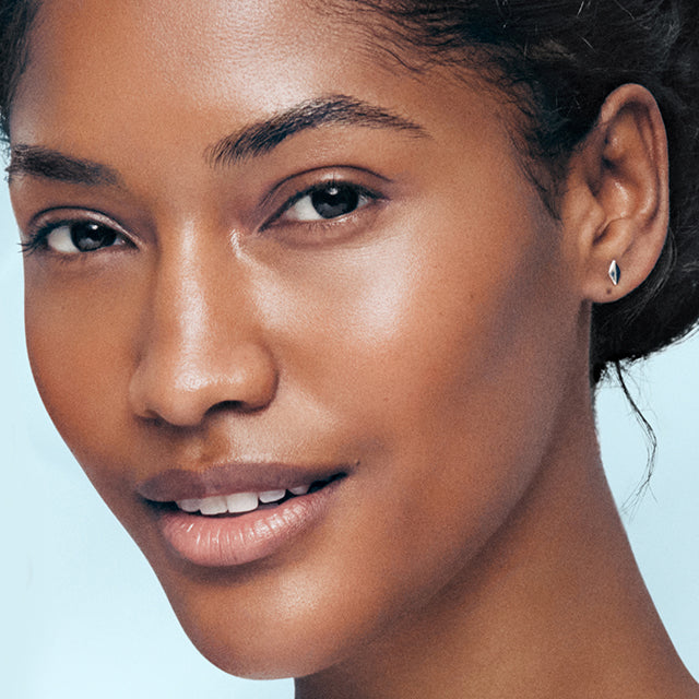 Close-up of a woman's face with a light blue background
