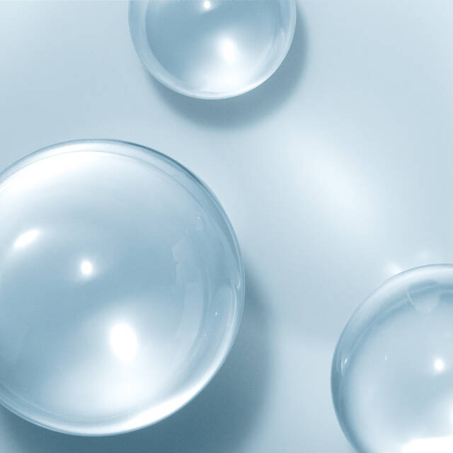 Size Shifting Hyaluronic Acid- Close-up of clear water droplets on a light blue background