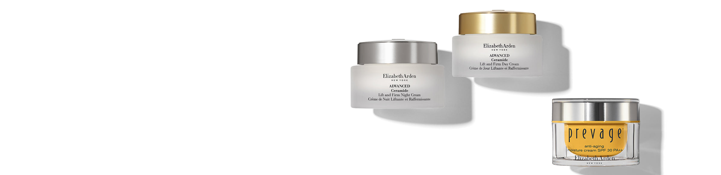 Three skincare jars with gold accents on a white background