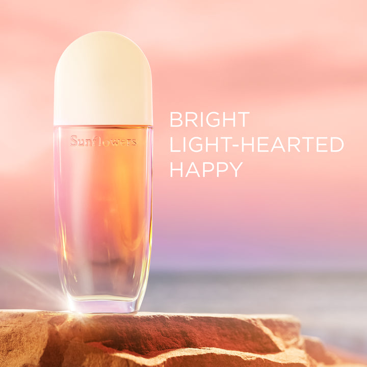 Perfume bottle with 'Sunflowers' branding on a pink and orange gradient background. Bright Light-hearted happy