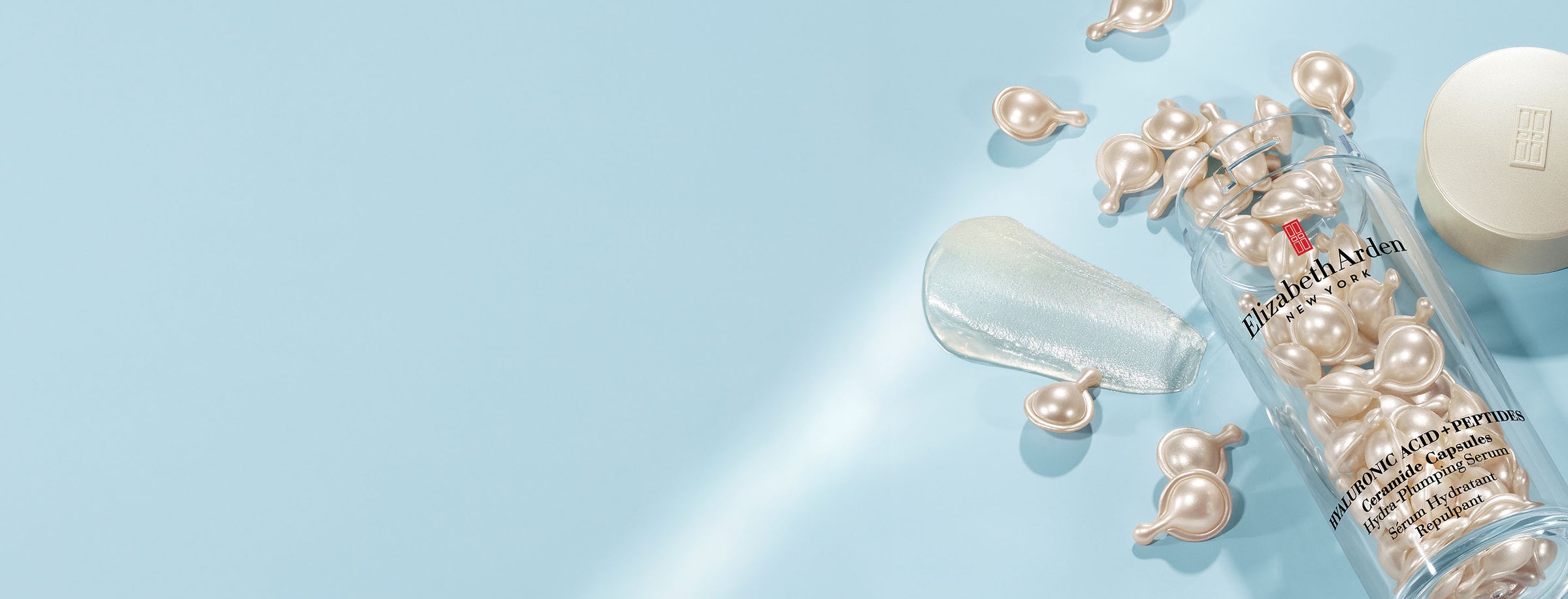 Hyaluronic Acid + Peptides Ceramide Capsules spilled on blue background