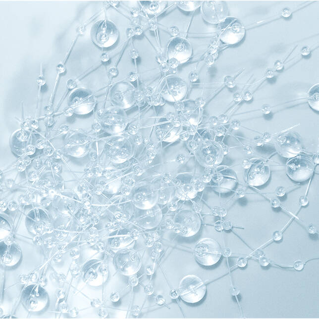 Peptide Complex- Close-up of clear water droplets on a light blue background
